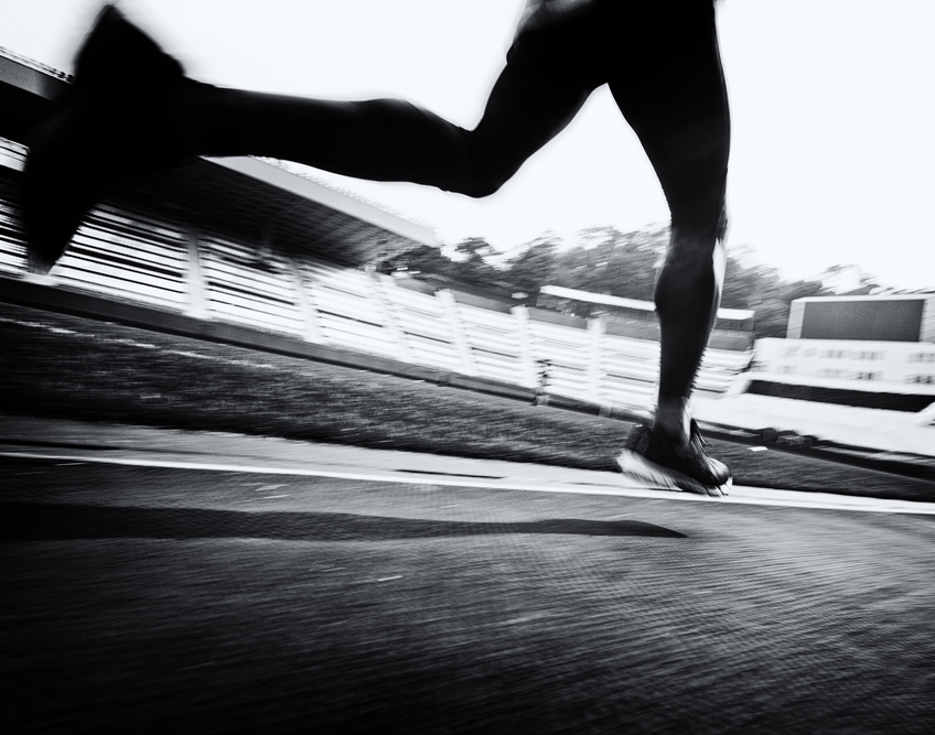 A sprinter in motion on a stadium track